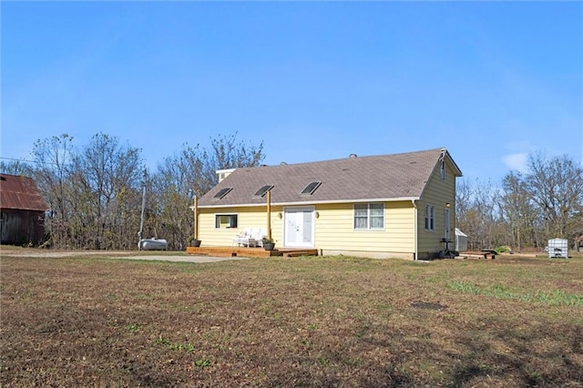 27977 W 311th St, Paola, KS 66071 - back of house with a lawn and a shingled roof