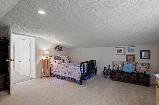 carpeted bedroom with lofted ceiling and a textured ceiling