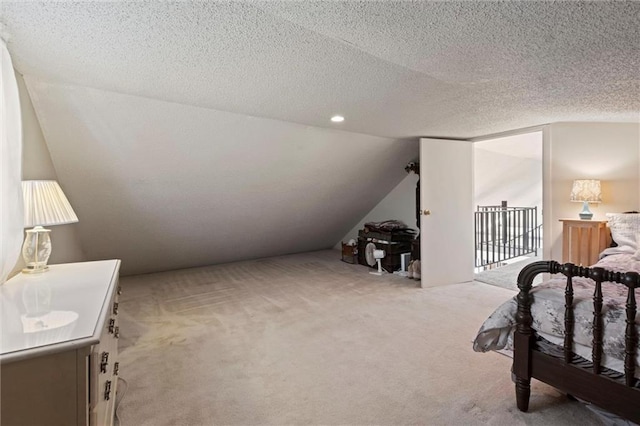 carpeted bedroom featuring a textured ceiling and vaulted ceiling