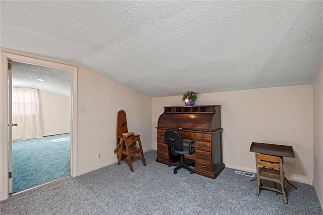 carpeted home office featuring a textured ceiling and vaulted ceiling