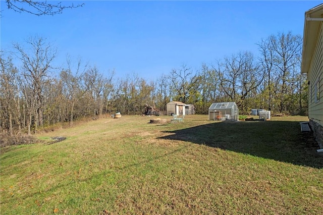 27977 W 311th St, Paola, KS 66071 - view of green lawn with a greenhouse and an outdoor structure