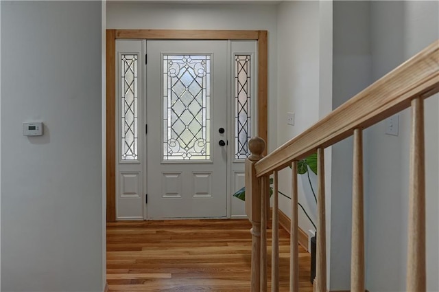 entrance foyer with stairway and wood finished floors