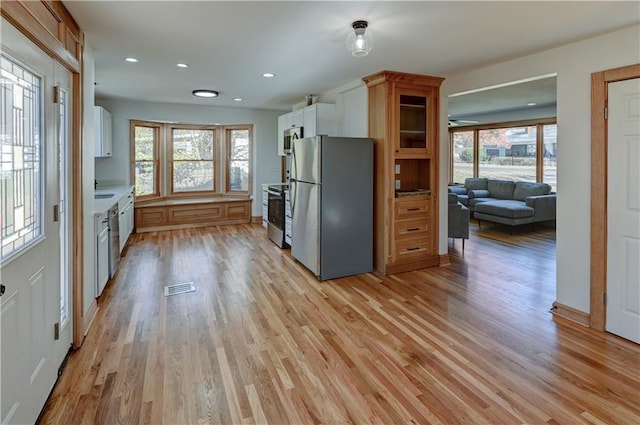 kitchen with stainless steel appliances, light wood-type flooring, visible vents, and recessed lighting