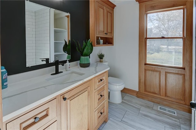 bathroom with visible vents, vanity, and toilet