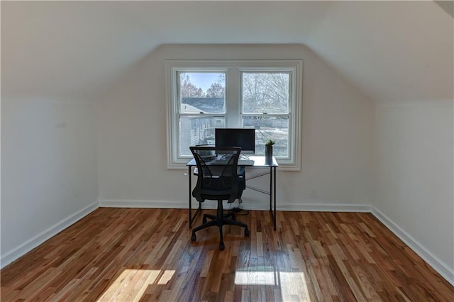 office area featuring baseboards, vaulted ceiling, and wood finished floors