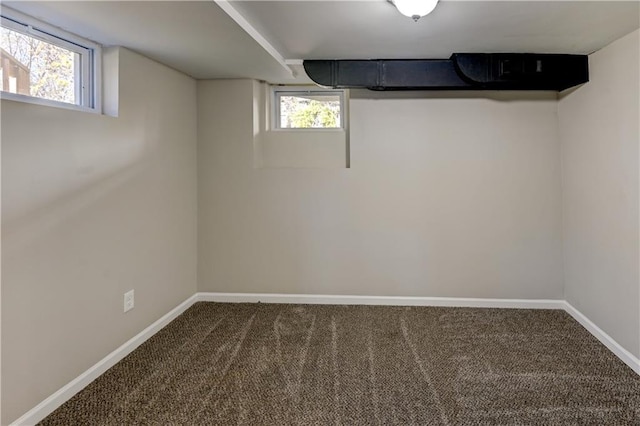 basement featuring carpet flooring and baseboards