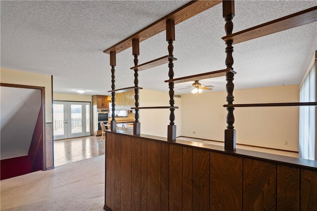 interior space with french doors and a textured ceiling