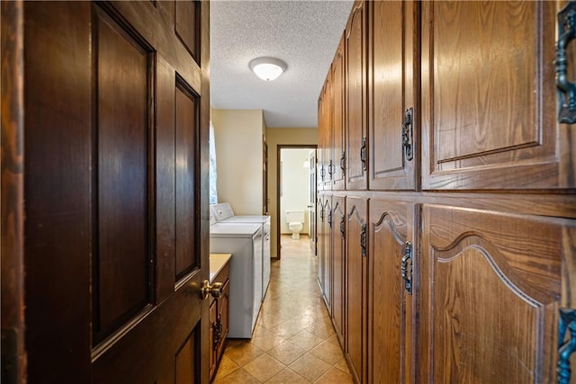 interior space with a textured ceiling and washing machine and dryer