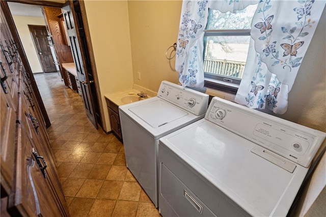 clothes washing area featuring sink and washing machine and clothes dryer