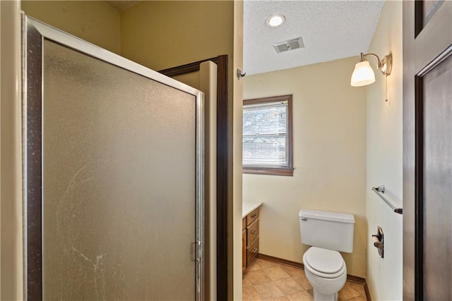 bathroom with vanity, a shower with shower door, a textured ceiling, and toilet