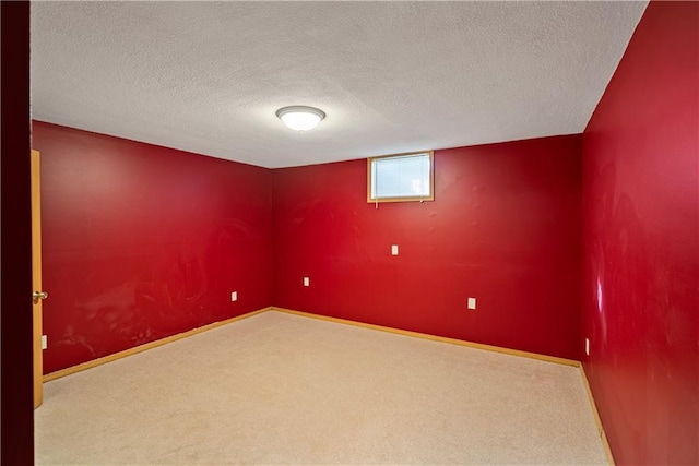 carpeted spare room with a textured ceiling