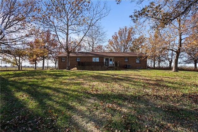 rear view of property featuring a yard