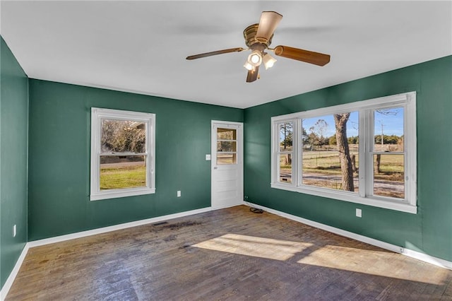 unfurnished room with dark hardwood / wood-style flooring and ceiling fan