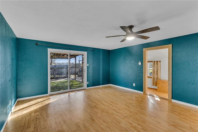 spare room featuring light hardwood / wood-style flooring and ceiling fan