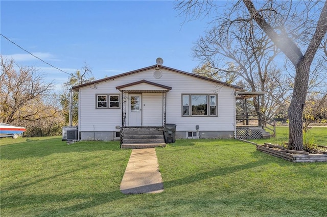 bungalow featuring cooling unit and a front lawn