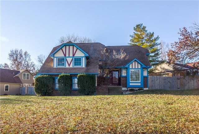 tudor-style house with a front lawn