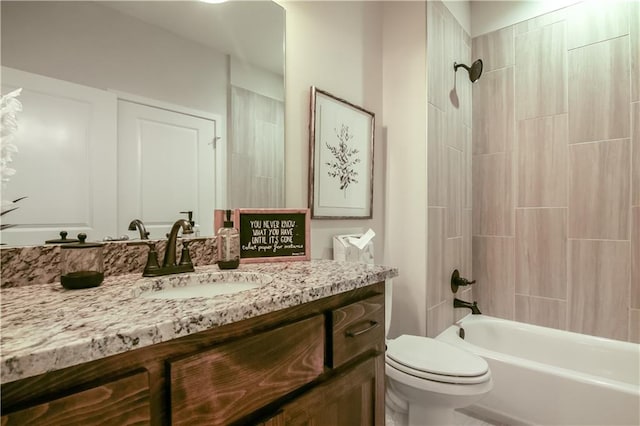 full bathroom with tiled shower / bath combo, toilet, and vanity