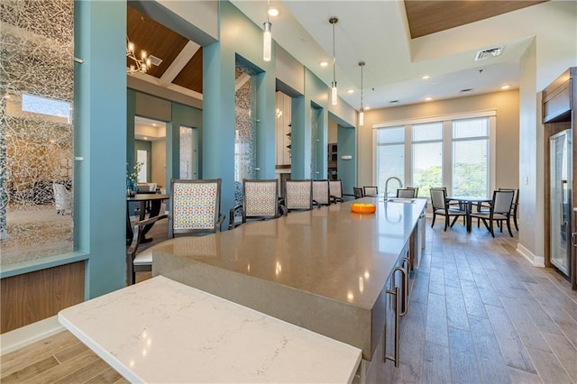 kitchen featuring pendant lighting, a center island, and hardwood / wood-style flooring