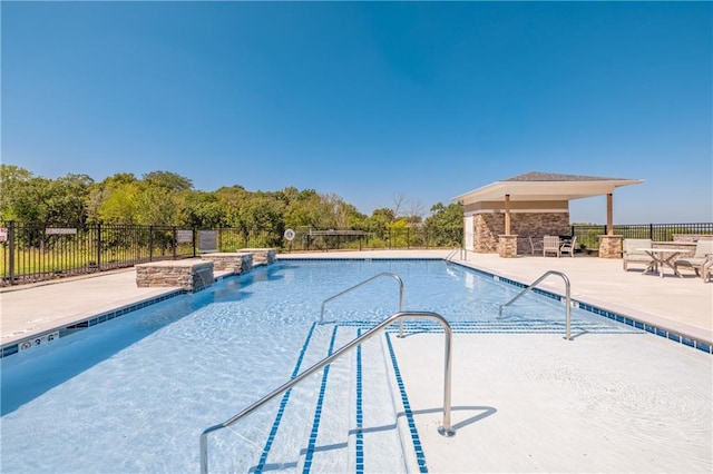 view of pool with a patio and pool water feature