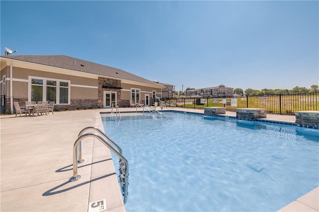 view of swimming pool featuring pool water feature and a patio area