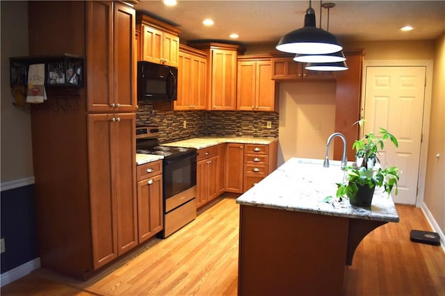 kitchen with light stone countertops, sink, decorative light fixtures, light hardwood / wood-style floors, and stainless steel electric range