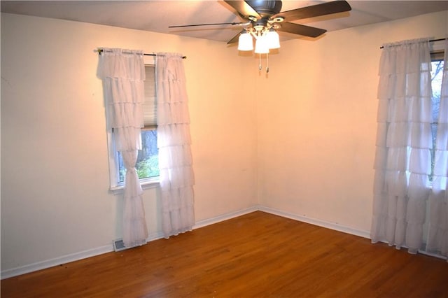 spare room with hardwood / wood-style flooring and ceiling fan