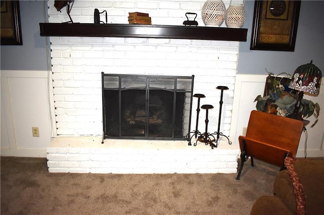 interior details featuring carpet and a brick fireplace