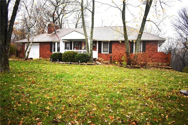 ranch-style home with a front lawn and a garage