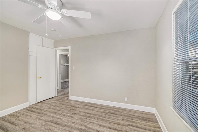 unfurnished bedroom featuring ceiling fan, a closet, and light hardwood / wood-style floors