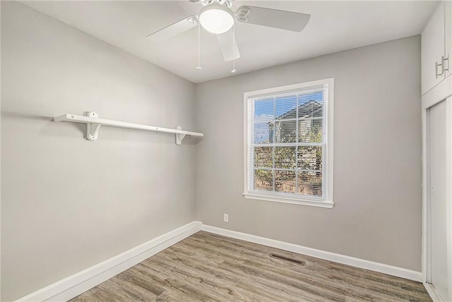 spare room featuring light wood-type flooring and ceiling fan