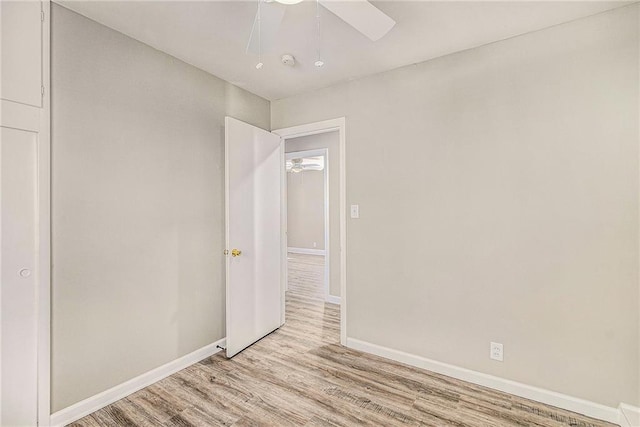 unfurnished bedroom with ceiling fan and light hardwood / wood-style flooring