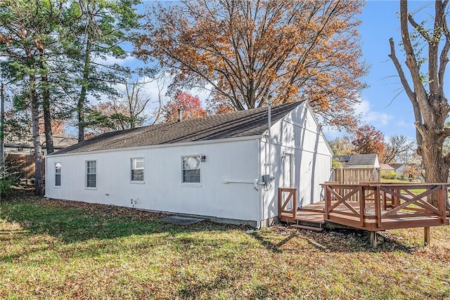 view of side of home with a yard and a deck