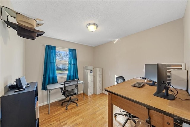 office area with a textured ceiling and light wood-type flooring