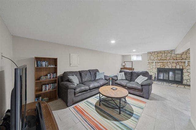 living room featuring light tile patterned flooring and a stone fireplace