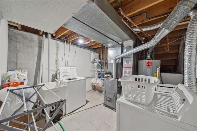 laundry room with gas water heater and washer and clothes dryer