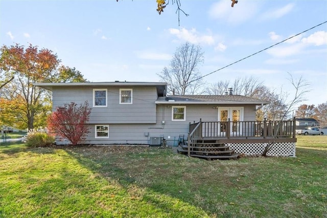 back of property featuring a lawn, central AC unit, and a deck