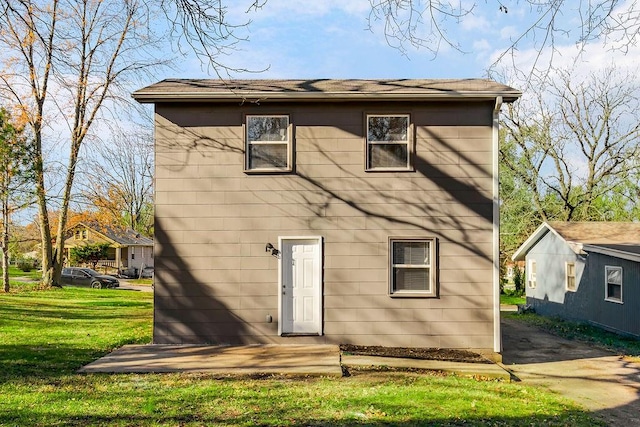 back of property with a lawn