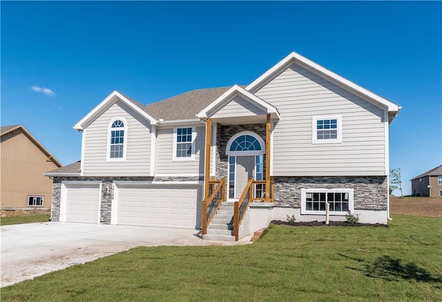 split foyer home with a front yard and a garage