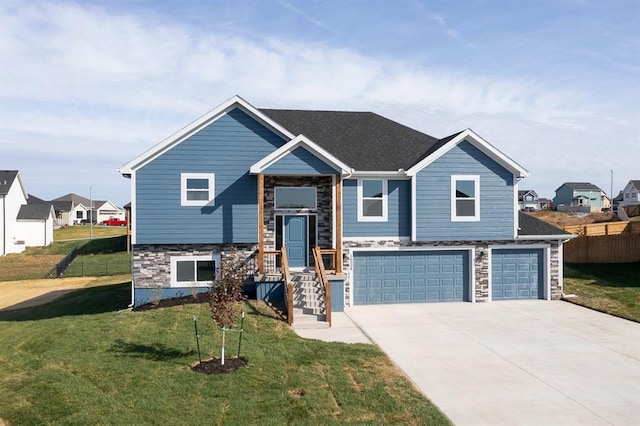 raised ranch with a garage and a front yard