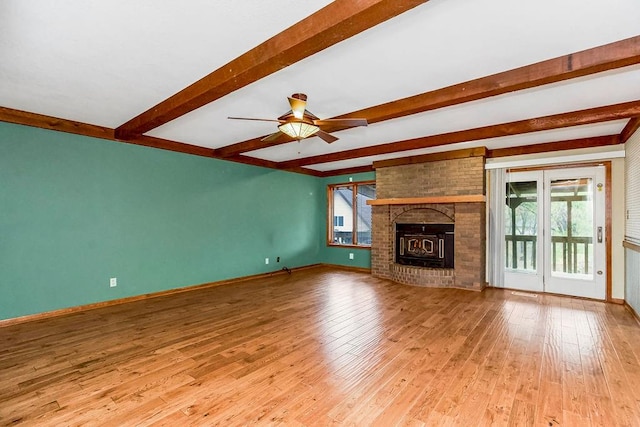 unfurnished living room featuring ceiling fan, beam ceiling, and light wood-type flooring