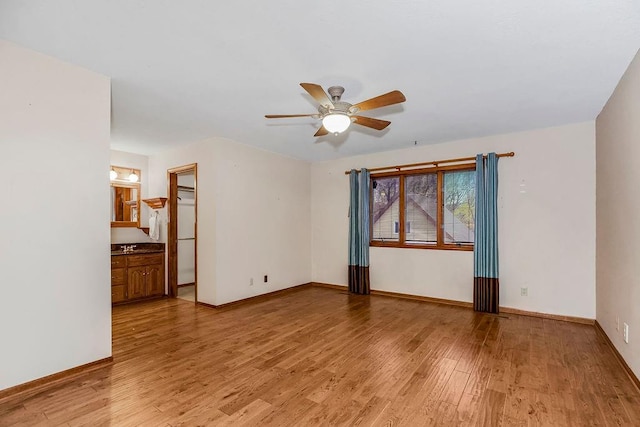 spare room with light hardwood / wood-style flooring and ceiling fan