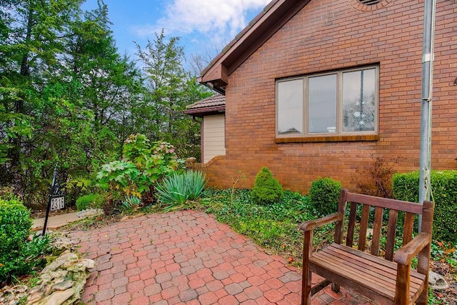 view of side of property with a patio