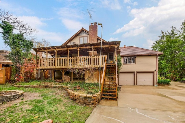 back of house featuring a garage and a deck