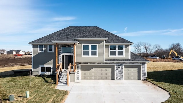 view of front of property with a front yard and a garage