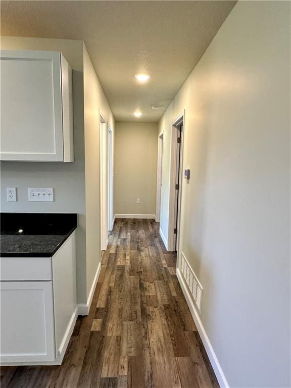 hall with dark hardwood / wood-style floors