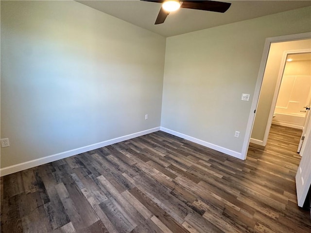 empty room with ceiling fan and dark hardwood / wood-style flooring