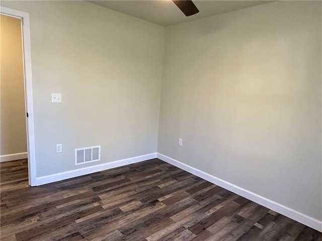 unfurnished room with ceiling fan and dark wood-type flooring