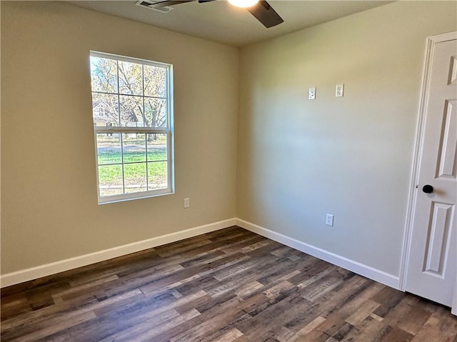 unfurnished room featuring ceiling fan and dark wood-type flooring