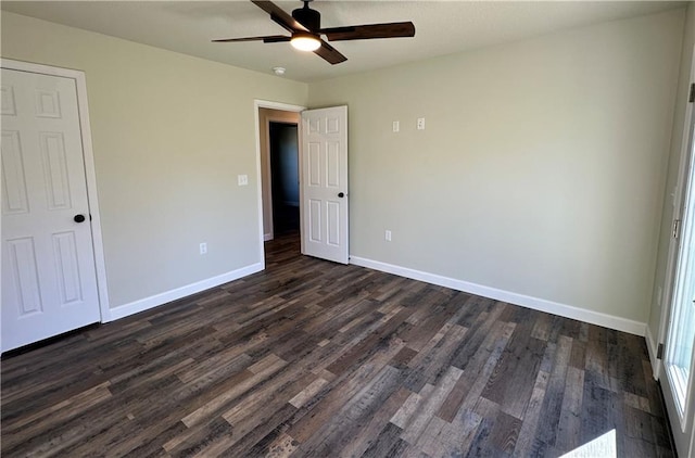 unfurnished bedroom featuring ceiling fan and dark wood-type flooring