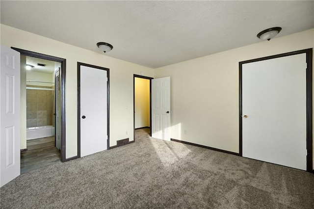 unfurnished bedroom with light carpet and ensuite bath